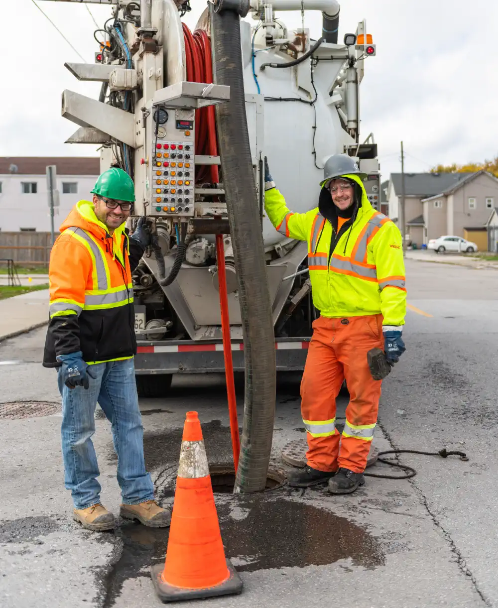 Staff at controls of flusher truck