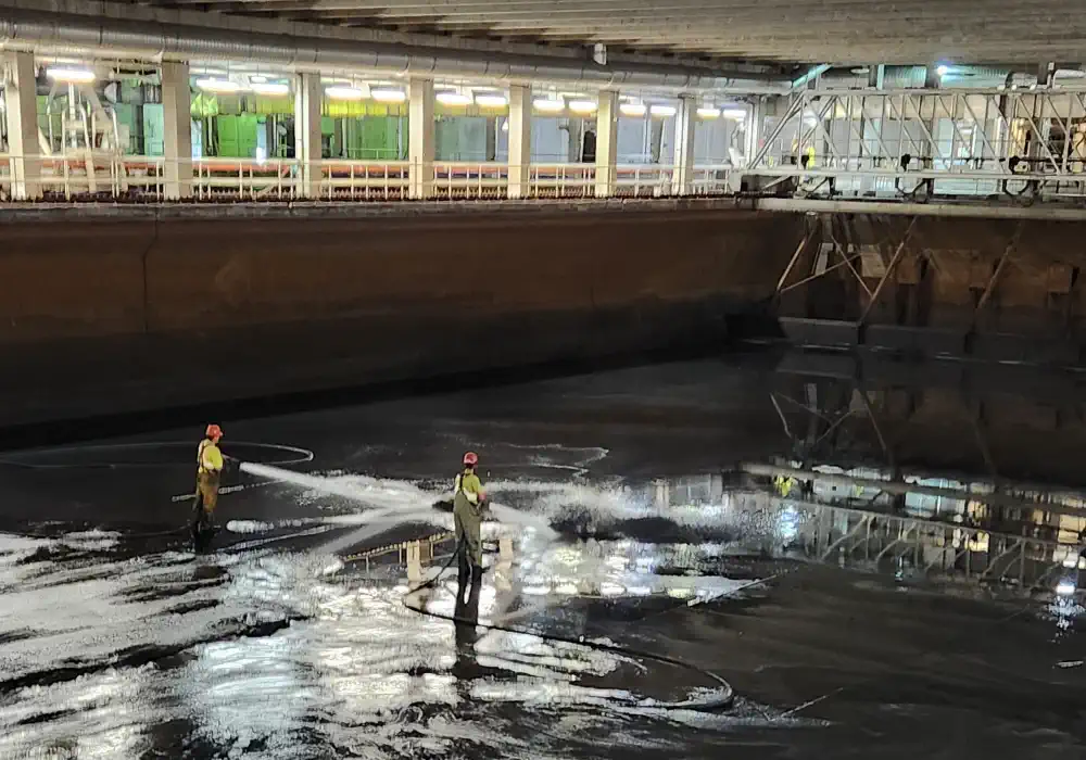 Staff cleaning a clarifier