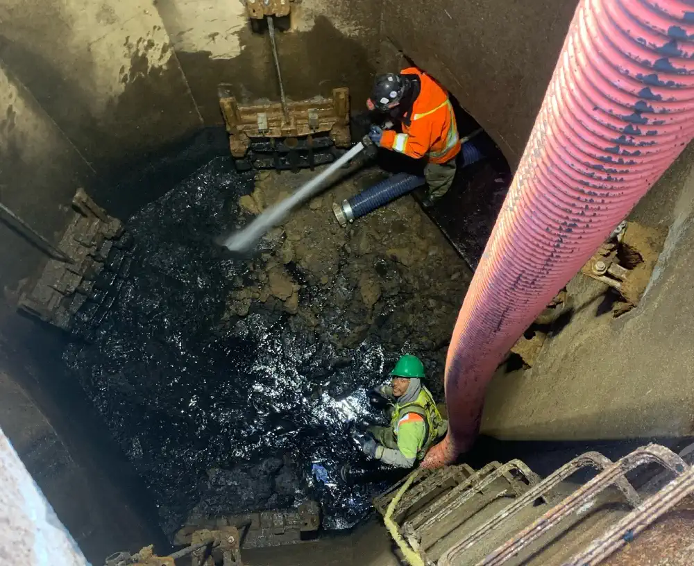 Staff cleaning the floor of a pumping station