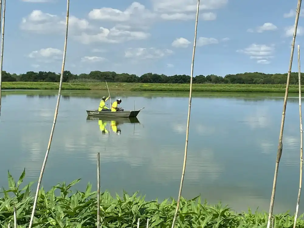 Lagoon being sampled by two people in a boat